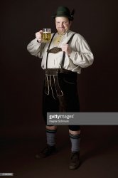 stereotypical-german-man-in-bavarian-costume-raising-a-beer-in-toast-picture-id81980896.jpg