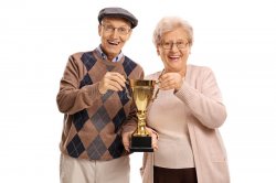 elderly-man-woman-holding-golden-trophy-men-women-isolated-white-background-98986482.jpg